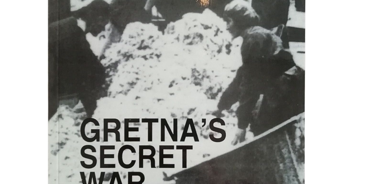 The front cover of Gretna's Secret War book by Gorden L. Routledge. It features a black and white photo of munitions workers working.