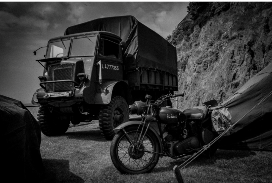 A military lorry and motorbike belonging to living history reenactors.