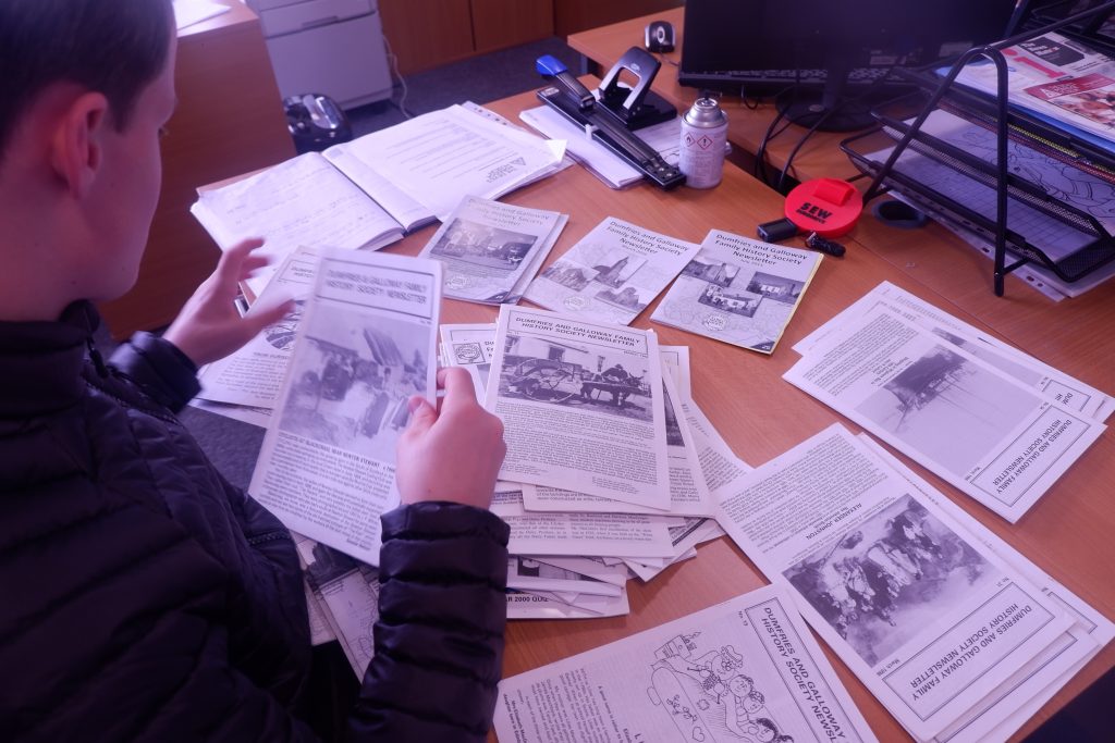 Someone sorting through pieces of paper in the office.