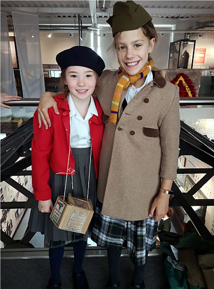 Two young people dressing up inside The Devil's Porridge Museum.
