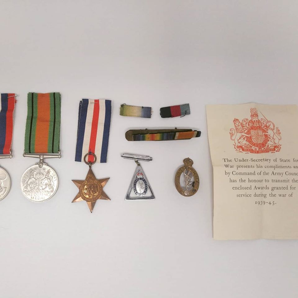 A selection of medals and a letter.