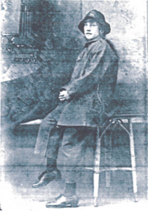 Annie Corrin sat on a chair. This is a black and white photo from the past.