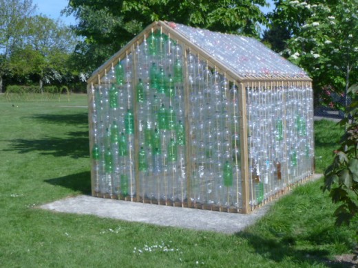 A green house made out of plastic bottles.