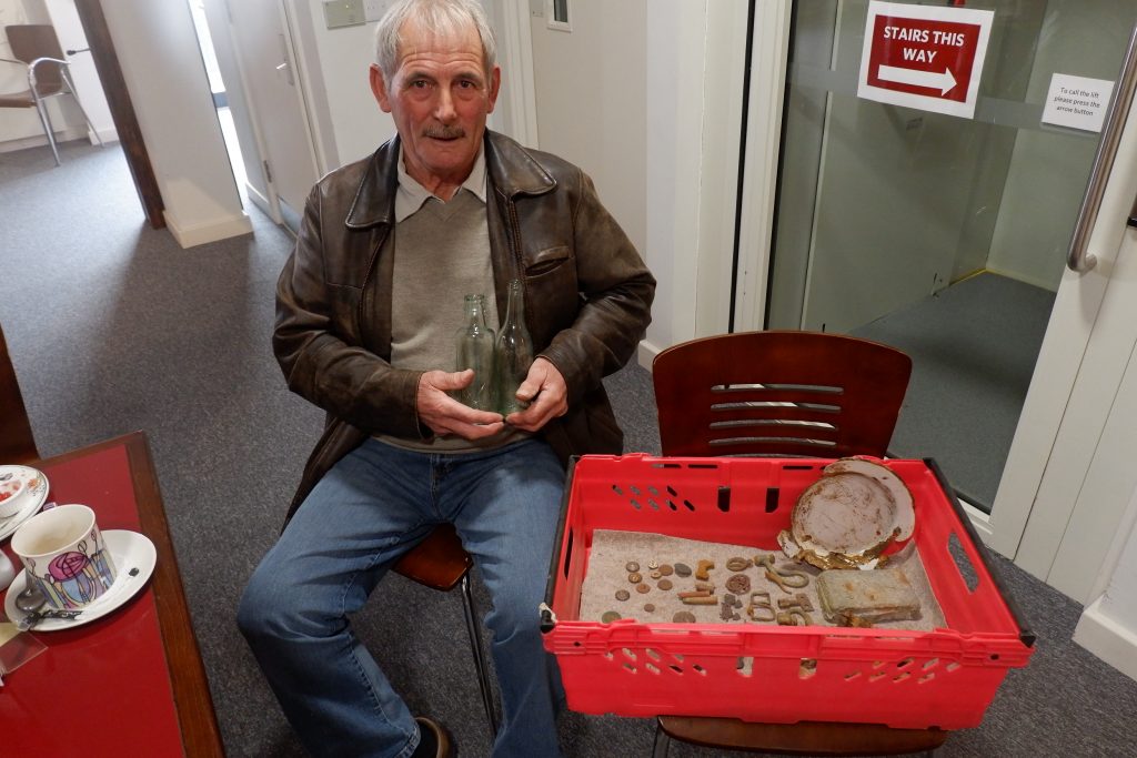 A man with his metal detector finds.