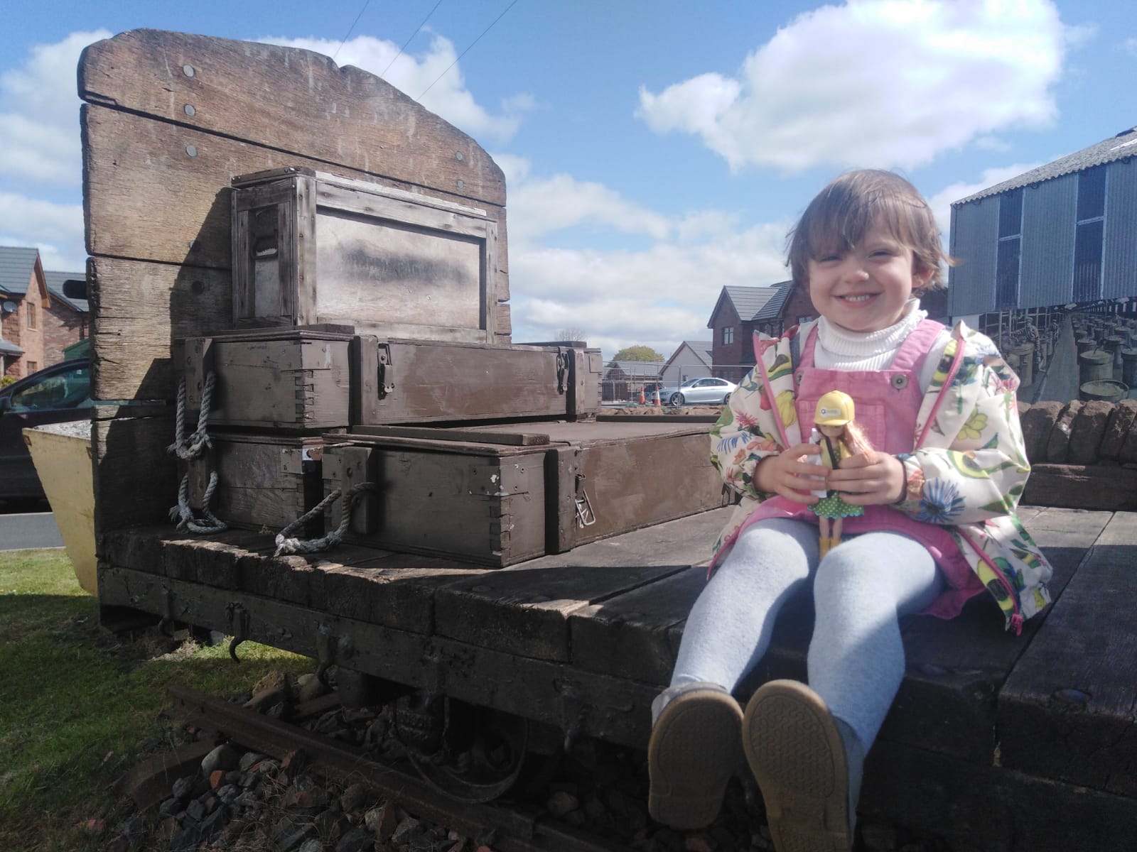 A child next to the railway bogie outside The Devil's Porridge Museum.