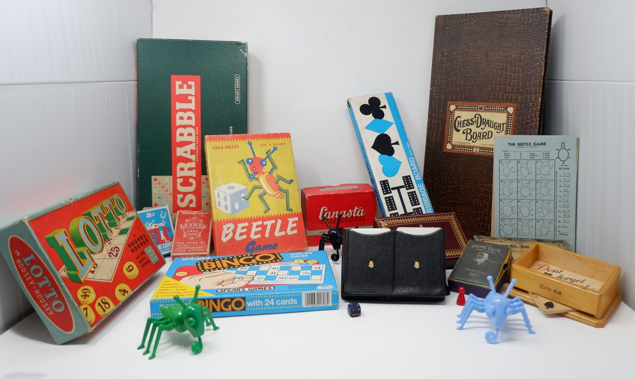 A collection of board games from the past. These include cards, scrabble, the beetle game, dominos and some card games.