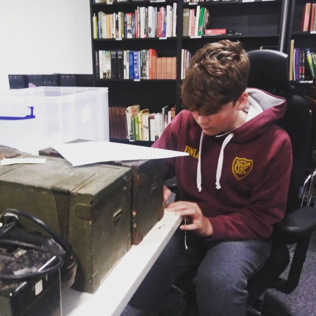 A Duke of Edinburgh student looking at a new donation.
