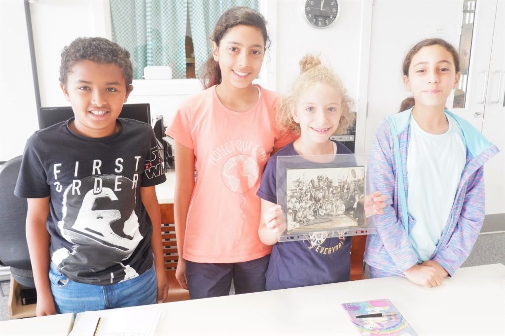Some young people with the archive photo that inspired them.