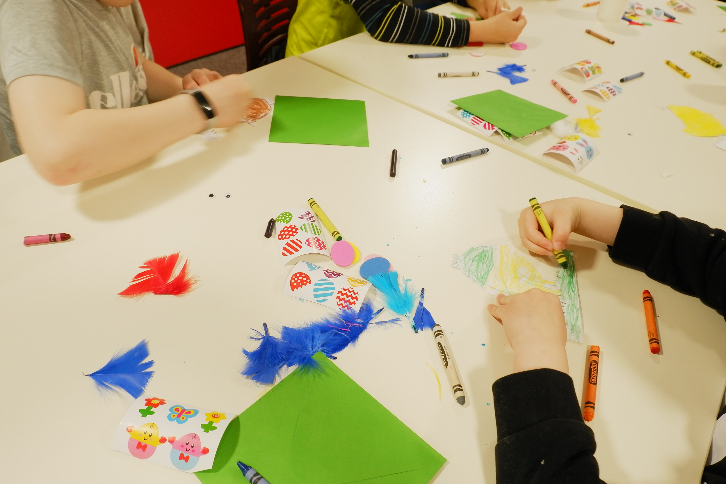 Some children colouring in at a table.
