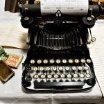 A typewriter on display on a table.