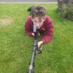 One of our museum team posing for a photo with a replica gun from the past.