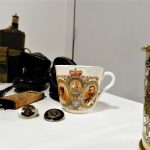 Some items including badges and a cup displayed on a table.