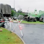 Rainy photo of some living history reenactors military vehicles outside The Devil's Porridge Museum.
