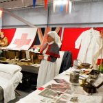 A living history reenactor dressed as a nurse in The Devil's Porridge Museum's education room.