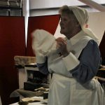 A living history reenactor dressed as a nurse from WW1.