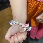 A handmade bracelet a child wears on their arm.