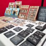 A table full of signs, coasters and keyrings made by the Scotia Crafters.
