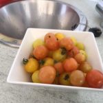Some red and yellow tomatoes in a bowl next to the sink in our café.