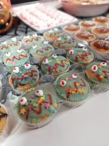Cupcakes decorated with green icing to look like monster faces with star sprinkles on.