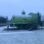 Sir James, a WW1, fireless locomotive stood outside in the snow.