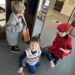 Three children wearing The Devil's Porridge Museum's dressing up clothes.