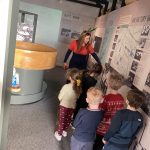A group of children follow the museum's Youth and Community Engagement Officer around the museum.