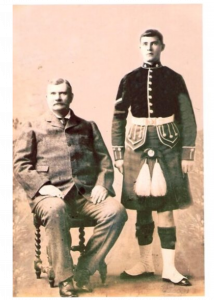 A black and white photo of Francis Thomas McLintic in his uniform and his father.