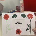 A card with a 2024 calendar and some flowers on the front.