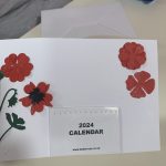 A card with a 2024 calendar and some flowers on the front.