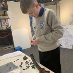 The Devil's Porridge Museum's Young Curator building a Lego planet.