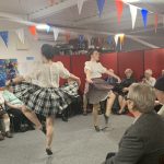 Two highland dancers dancing at the museum's Burns Supper.