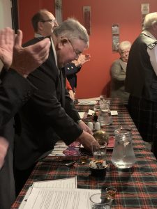A man addressing the haggis.
