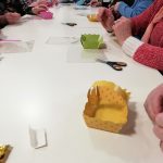 Some members of the museum's Cordite Club sat at a table making Easter baskets.