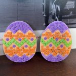 Two Easter eggs decorated with foam shapes.