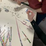 Making handmade beads from paper.