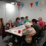 A table of Cordite Club members playing a card game.