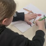 A young person drawing.