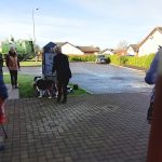 A person and dog representing The Devil's Porridge Museum laying a wreath at the animals in war memorial.