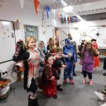 Young people posing in their Halloween costumes.