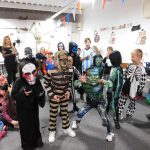 Young people posing in their Halloween costumes.