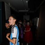 Children in Halloween costumes in the trench section of The Devil's Porridge Museum. One is sticking their tongue out.