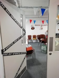 The doors into The Devil's Porridge Museum's education room decorated with Halloween bunting.