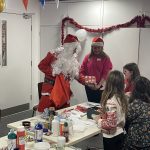 Santa giving a Christmas present to a child.