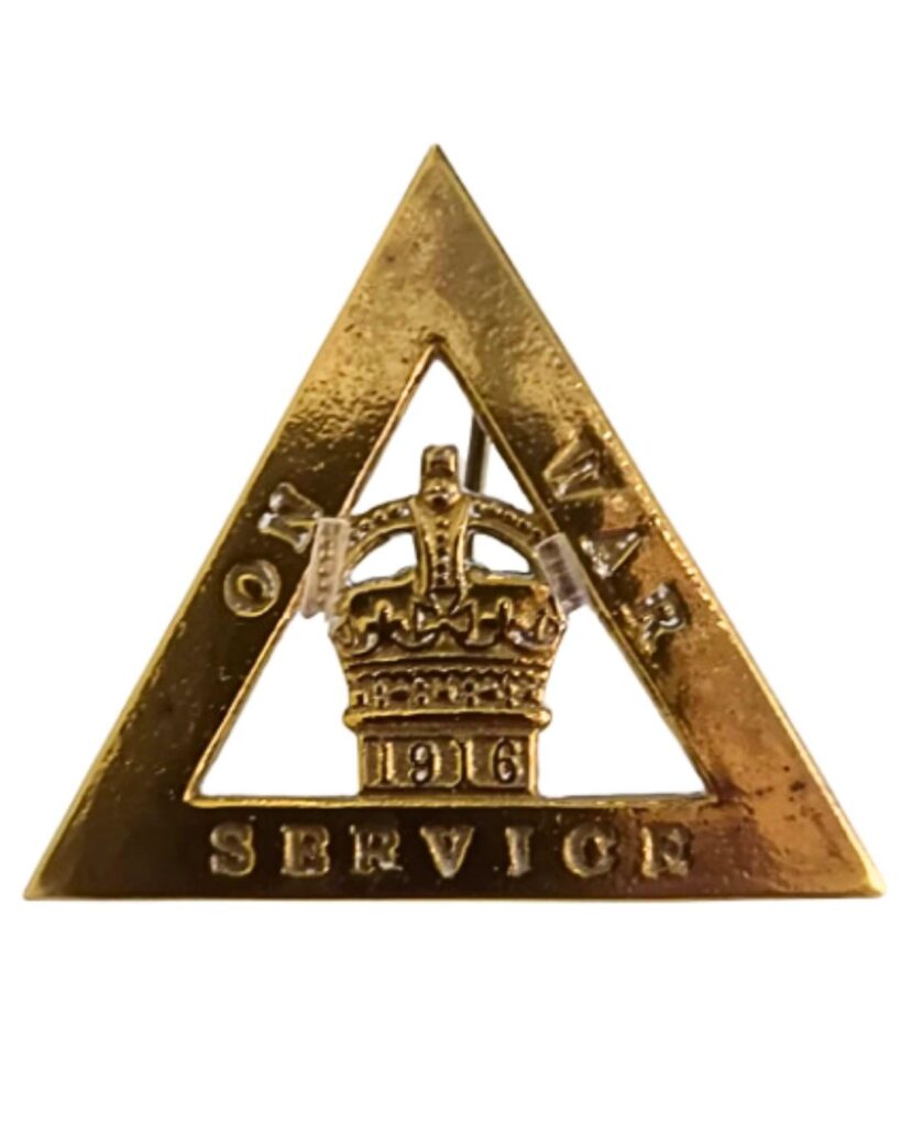 A brass On War Service badge.