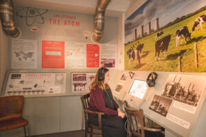 A visitor sat listening to a video in the Chapelcross section of The Devil's Porridge Museum.