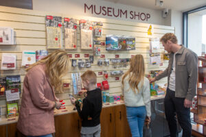 A family looking at The Devil's Porridge Museum's gift shop.