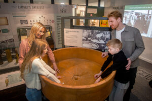 A family at a nitrating pan on display in The Devil's Porridge Museum.