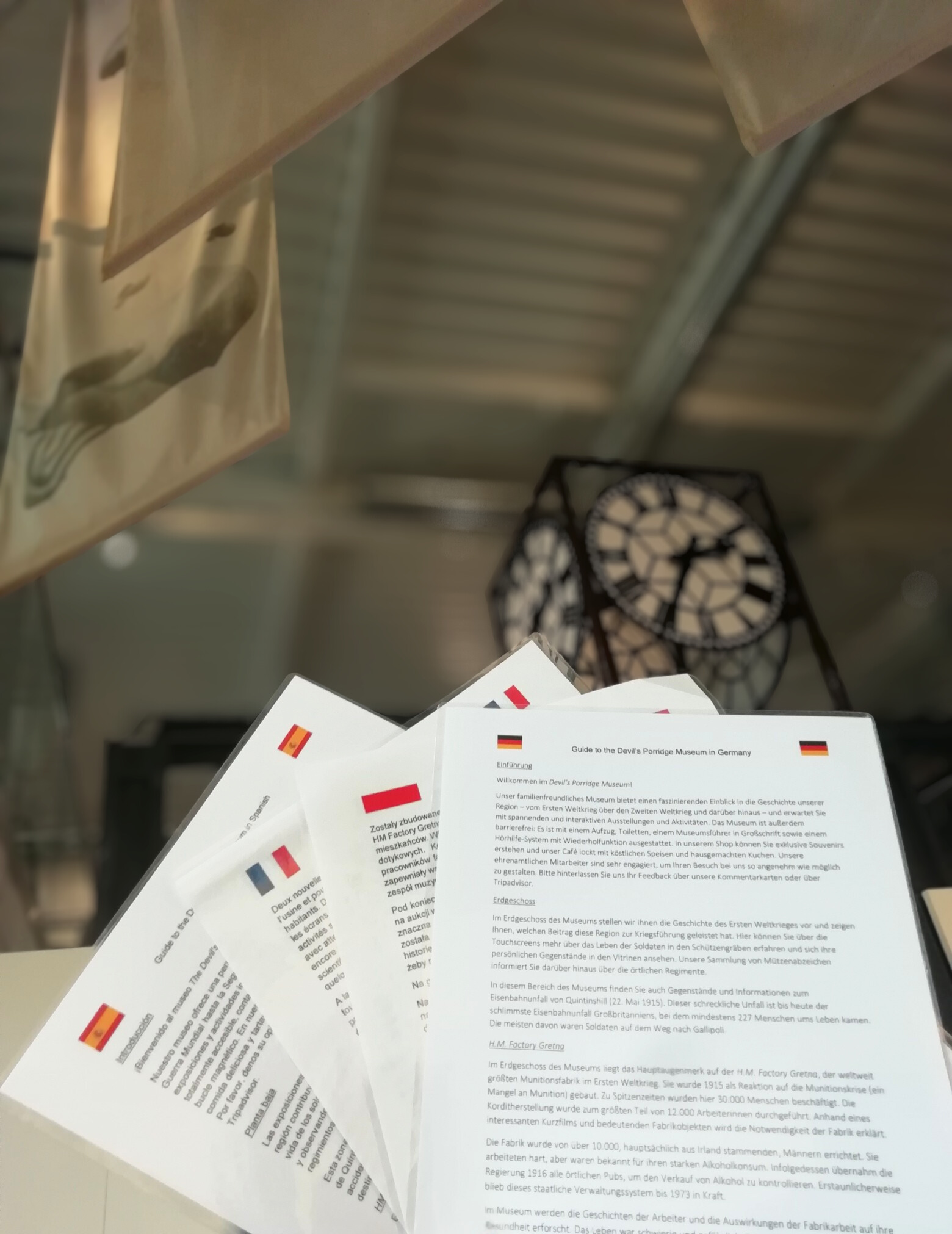 Information sheets about The Devil's Porridge Museum written in Spanish, French, Polish and German. The Devil's Porridge Museum's Mossband Clock is in the background.