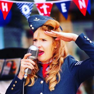 A singer dressed in a military uniform.