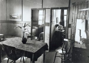 A table with doorways into a bedroom. This is inside a hostel for H.M. Factory Gretna in the past.